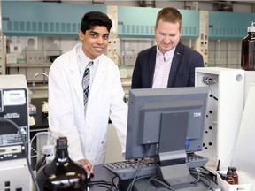 High school student Marcus Deans, left, meets with Dr. James Gauld in the University of Windsor chemistry teaching lab on March 24, 2017.