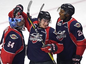 After winning a Memorial Cup title, Windsor Spitfires goaltender Michael DiPietro, left, and congratulated by teammates Gabriel Vilardi, centre, are now in Buffalo to participate in the NHL Draft Combine.