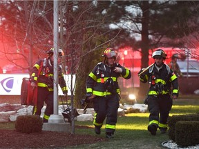 Windsor firefighters work at the scene of a fire at Cavalier Tool & Manufacturing Ltd. at 450 Wheelton Dr. on March 29, 2017.