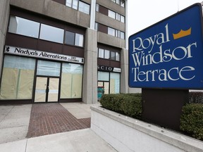 Two storefront windows are covered on Park Street West on March 9, 2017. The business spaces are part of the Royal Windsor Terrace complex.