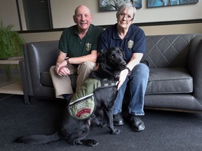 Veterans Richard Hummell and his partner Karen Ann Sutcliffe sit with National Service Dog Bailey (NSD BAILEY) at their Windsor residence on March 9, 2017. Bailey is the service dog for Sutcliffe who is a veteran.