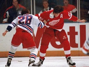 FILE - In this Dec. 2, 1992, file photo, New York Rangers Tie Domi (28) fights with Detroit Red Wings Bob Probert (24) less than a minute into the first period of the game at New York&#039;s Madison Square Garden. Probert&#039;s widow, Dani, sprinkled some of the late enforcer&#039;s ashes in the penalty box during the final game at Detroit&#039;s Joe Louis Arena on April 9, 2017. (AP Photo/Ron Frehm, File)