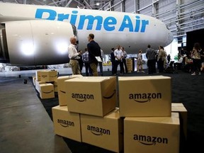FILE - In this Thursday, Aug. 4, 2016, file photo, Amazon.com boxes are shown stacked near a Boeing 767 Amazon &ampquot;Prime Air&ampquot; cargo plane on display in a Boeing hangar in Seattle. Retail subscription programs, such as Amazon Prime, promise free shipping to members for a monthly or yearly fee. As shoppers demand speed, some cyberstores are offering free and fast shipping, albeit with minimum-purchase requirements. Certain situations, however, may warrant paying the membership fee. (AP Photo/Ted S. W