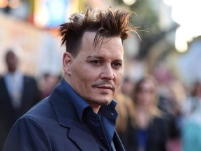 FILE - In this May 23, 2016, file photo, Johnny Depp arrives at the premiere of &ampquot;Alice Through the Looking Glass&ampquot; at the El Capitan Theatre in Los Angeles. Some visitors to the Pirates of the Caribbean ride at California‚Äôs Disneyland got a surprise Wednesday, April 26, 2017, when Depp appeared as Captain Jack Sparrow inside the ride. (Photo by Jordan Strauss/Invision/AP, File)