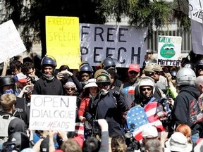 A crowd gathers around speakers during a rally for free speech Thursday, April 27, 2017, in Berkeley, Calif. Demonstrators gathered near the University of California, Berkeley campus amid a strong police presence and rallied to show support for free speech and condemn the views of Ann Coulter and her supporters. (AP Photo/Marcio Jose Sanchez)