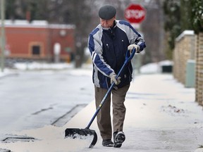 John Shorten shovels the snow off the sidewalk along Brighton Rd. near his Tecumseh Ont. home on Thurs. Nov. 28, 2013.  The city is looking for Snow Angel volunteers to help seniors keep their walkways clear this winter. (DAN JANISSE/The Windsor Star)