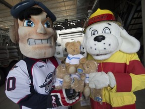 Bomber, the Windsor Spitfires mascot, left, and Sparky, from Windsor Fire and Rescue Services, hold teddy bears donated to Sparky's Toy Drive by the Windsor Spitfires and longtime community partner Mopar while at Windsor Fire Station No. 7 on April 27, 2017. More than 600 teddy bears were donated.