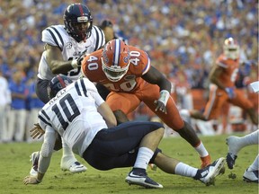 This Oct. 3, 2015, file photo shows Mississippi quarterback Chad Kelly (10) being sacked by Florida linebacker Jarrad Davis (40) during the first half of an NCAA college football game in Gainesville, Fla. Davis was taken in the first round by the Detroit Lions in the 2017 NFL Draft.