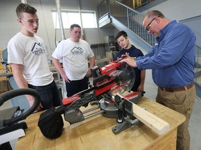 St. Joseph's students Thomas Kennedy, left, Josh Gaudreau and Jacob Gagnier receive instruction from teacher Cory McAiney on April 19, 2017, during the announcement of Windsor-Essex Catholic District School Board's Construction Academy.