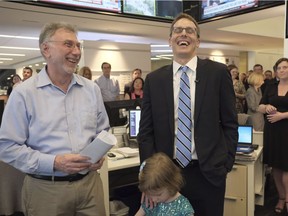Washington Post editor Martin Baron, left, joins the paper's staff in congratulating David Fahrenthold, centre, upon learning that he won the Pulitzer Prize for National Reporting, for dogged reporting of Donald Trump's philanthropy, in the newsroom of the Washington Post in Washington on Monday, April 10, 2017.