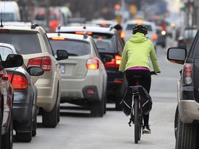 Alysha Baker cycles on Ouellette Ave. in downtown Windsor, Ont., on March 17, 2017.