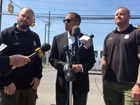 Detroit Police Chief James Craig, centre, speaks about Detroit police officers Brian Gadwell, right, and Steven Rauser during a news conference on April 18, 2017, in Detroit. Gadwell and Rauser responded to a 911 call late Monday night from Riverside Park in southwest Detroit to find the woman trying to hold onto a branch another man was dangling down to her. The two Detroit police officers are being credited with helping save a drowning pregnant woman who later gave birth.