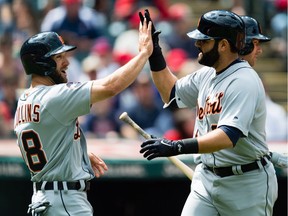 Tyler Collins #18 celebrates with Alex Avila #31 of the Detroit Tigers after both scored on a home run by Avila during the second inning against the Cleveland Indians at Progressive Field on April 16, 2017 in Cleveland, Ohio.