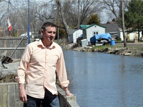 Dan Burke looks out to the high waters of the Ruscom River behind his home in St. Joachim, Ont.