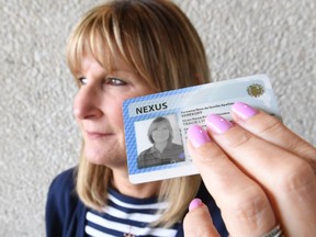 Tracie Berekoff from the Windsor Power and Sail Squadron holds up her NEXUS card on April 7, 2017 to let boaters know that it is needed to cross into the United States by boat.