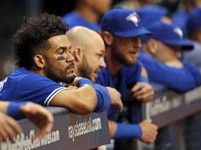Toronto Blue Jays' Devon Travis, left, looks on during the ninth inning of a 7-2 loss to the Tampa Bay Rays in a baseball game, Sunday, April 9, 2017, in St. Petersburg, Fla.