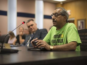 Shiva Koushik, chair of the Anaphylaxis Project Committee, is joined by Dr. Paul Bradford, left, an area physician, as he speaks to city council on the proposed plan for a one year pilot project for EpiPens in city owned facilities on April 24, 2017.