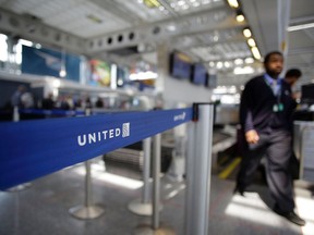 This file photo taken on April 12, 2017 shows an airport worker walking through the United Airlines terminal at O'Hare International Airport in Chicago, Ill.
