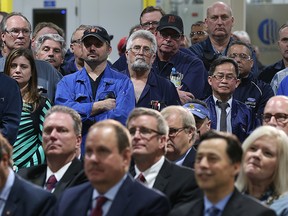 Workers and dignitaries at Ford's Essex Engine Plant in Windsor listen at a press conference with company executives and government officials on March 30, 2017.