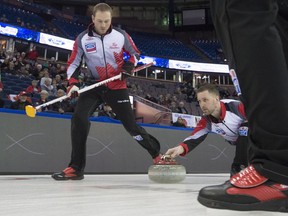 Canada skip Brad Gushue makes a shot as lead Geoff Walker, left, and second Brett Gallant sweep during the 13th draw against Japan at the Men's World Curling Championships in Edmonton on April 5, 2017.