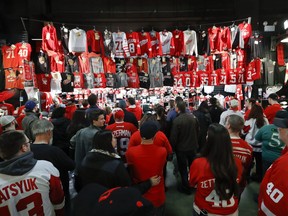 In this Sunday, March 26, 2017, photo, Detroit Red Wings fans line up to buy merchandise at Joe Louis Arena before an NHL hockey game, in Detroit. The arena will be the home of the Red Wings one more time on Sunday, April 9, when they host the New Jersey Devils. The game will mark the end of the era at a storied arena, where the Red Wings have hoisted four of their 11 Stanley Cup banners to the crowded rafters where all-time greats such as Gordie Howe and Steve Yzerman have their retired jerseys hanging.