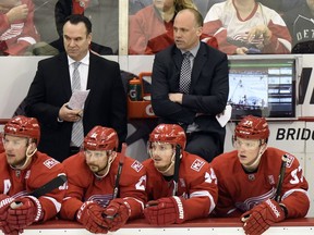 Detroit Red Wings head coach Jeff Blashill, centre background, watches his team play against the Ottawa Senators during the first period of an NHL hockey game on April 3, 2017, in Detroit.