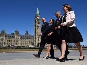 Parliamentary Secretary Bill Blair, left, Justice Minister and Attorney General of Canada Jody Wilson-Raybould, Public Safety and Emergency Preparedness Minister Ralph Goodale and Health Minister Jane Philpott make their way to the National Press Theatre in Ottawa on April 13, 2017.