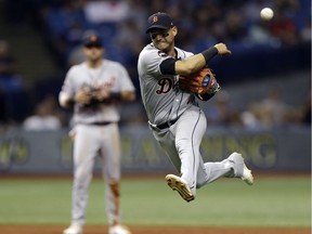 Detroit Tigers shortstop Jose Iglesias leaves his feet as he throws out Tampa Bay Rays' Derek Norris at first during the seventh inning of a baseball game on April 19, 2017, in St. Petersburg, Fla.