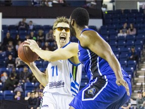 Logan Stutz of the Niagara River Lions runs the ball past George Blakeney of the KW Titans during NBL of Canada action on Thursday, March 23, 2017.