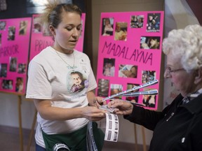 Sarah Taiariol, aunt to Madalayna Ducharme, sells raffle tickets at a fundraiser for Ducharme at Parkwood Gospel Temple, Saturday, April 1, 2017.  Madalayna suffers from Malignant Infantile Osteopetrosis.