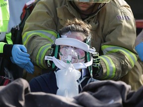 Paramedics and firefighters extricate a victim in a mock accident on Wednesday, April 26, 2017 at the Tecumseh Vista Academy. The simulation was part of a day-long event to highlight to teens the dangers of distracted and impaired driving.