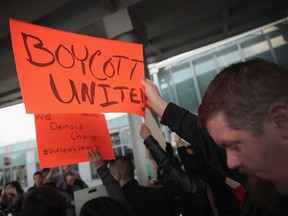 Demonstrators protest outside the United Airlines terminal at O'Hare International Airport on April 11, 2017 in Chicago, Ill.