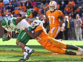 Tennessee linebacker Jalen Reeves-Maybin drags down North Texas tight end Marcus Smith during the second half of an NCAA college football game at Neyland Stadium in Knoxville, Tenn., on Nov. 14, 2015.