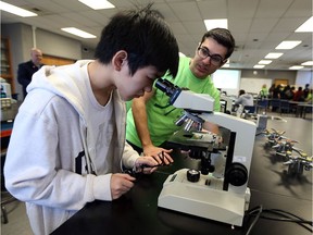 Anthony Pisciuneri,
right, talks with high school student Don Bui during a cancer research symposium at the University of Windsor in Windsor on Feb. 23, 2017. Windsor will be part of the more than 400 Marches for Science to be held in 37 countries around the world on April 22.