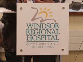 The sign on the front of the podium at a May 2016 news conference reads — Windsor Regional Hospital: Outstanding care … no exceptions!
