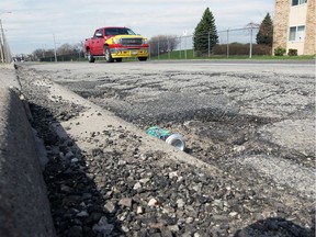 Potholes and cracked pavement mar Seminole Street in Windsor, as photographed on April 10, 2017.