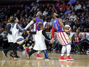 With young fans in tow, two Harlem Globetrotters entertain the crowd at the WFCU Centre in Windsor on April 13, 2017.