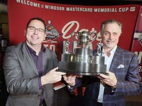 Windsor Spitfires alumnus Bill Bowler, left, and Spitfires co-owner John Savage hold a 2009 replica of the Memorial Cup won by the Windsor Spitfires during a news conference on April 19, 2017 announcing a CHL alumni game and an impressive list of community engagement events scheduled for 2017 Memorial Cup at the WFCU Centre.