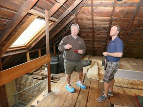 Home inspectors Bob Price, left, and his son, Nick Price, take a close look inside the attic of a Walkerville home.
