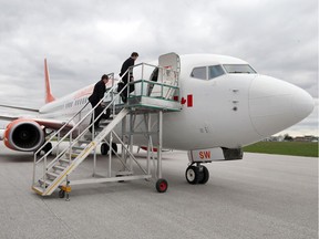 Sunwing Vacation first officer James Parsons and captain Peter Budnik board the jet before departing from Windsor Airport on April 21, 2017.
