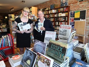 Casey Plett (left) publicity and marketing coordinator and Dan Wells, publisher of Biblioasis in Windsor, hold a selection of books by local authors  on April 25, 2017.
