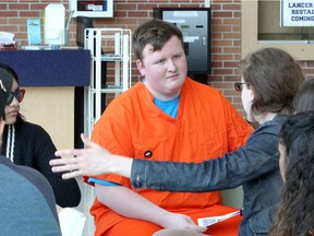 Matthew Dunlop, centre, Student Alliance vice-president of student advocacy, listens to tuition concerns from other University of Windsor students and graduates at the CAW Student Centre on April 25, 2017.