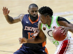 Windsor Express forward Shaquille Keith, right, drives on Island Storm Terry Thomas in NBL Canada action . The two teams were set to meet Friday at the WFCU Centre, but the weather has forced the game to be postponed until March.