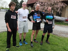 Top runners Blake Doe, left, Matt Charbonneau, Murray Paddon and Dan Beauchesne, right, celebrate after completing in the Hills for Heroes Run/Walk course at Malden Park April 30, 2017.