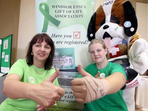 Niva Segatto, left, chairperson of the Windsor-Essex Gift of Life Association, and kidney recipient Breanna Van Watteghem show their approval for organ donors on Wednesday during a charity pasta fundraiser at the Caboto Club. Segatto said up to 1.8 million Ontario residents mistakenly believe they are registered organ and tissue donors.
