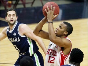 Darren Duncan of the Windsor Express pulls up and shoots against Niagara River Lions Sammy Zeglinski in NBL Canada action from the WFCU Centre on April 5, 2017.