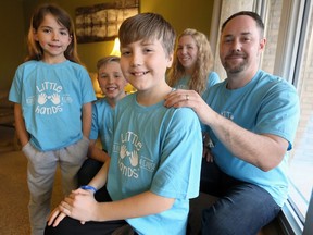 Kaleb Houle, 11, centre, surrounded by his family, sister Olivia, 8, left, brother Jace, 9, and parents Jennifer and Devin, right, at their Forest Glade home April 6, 2017.