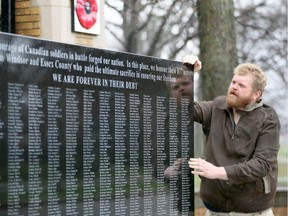 Vimy history tour guide Matt Pritchard looks at  Windsor's First World War memorial at the gates of Memorial Park on Ypres Boulevard April 6, 2017.