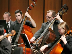 Windsor Symphony Youth Orchestra member Luca Marrello, left,  performs alongside WSO double bassist Greg Sheldon at the Capitol Theatre, Friday, April 7, 2017.