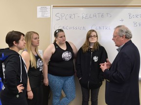 Border City Brawlers coach Justine Arbour, and team members Julia Valeriani, left, Becky Mathers and Leith Bergenhus listen to Dr. Joe Casey at the University of Windsor on Saturday April 8, 2017.